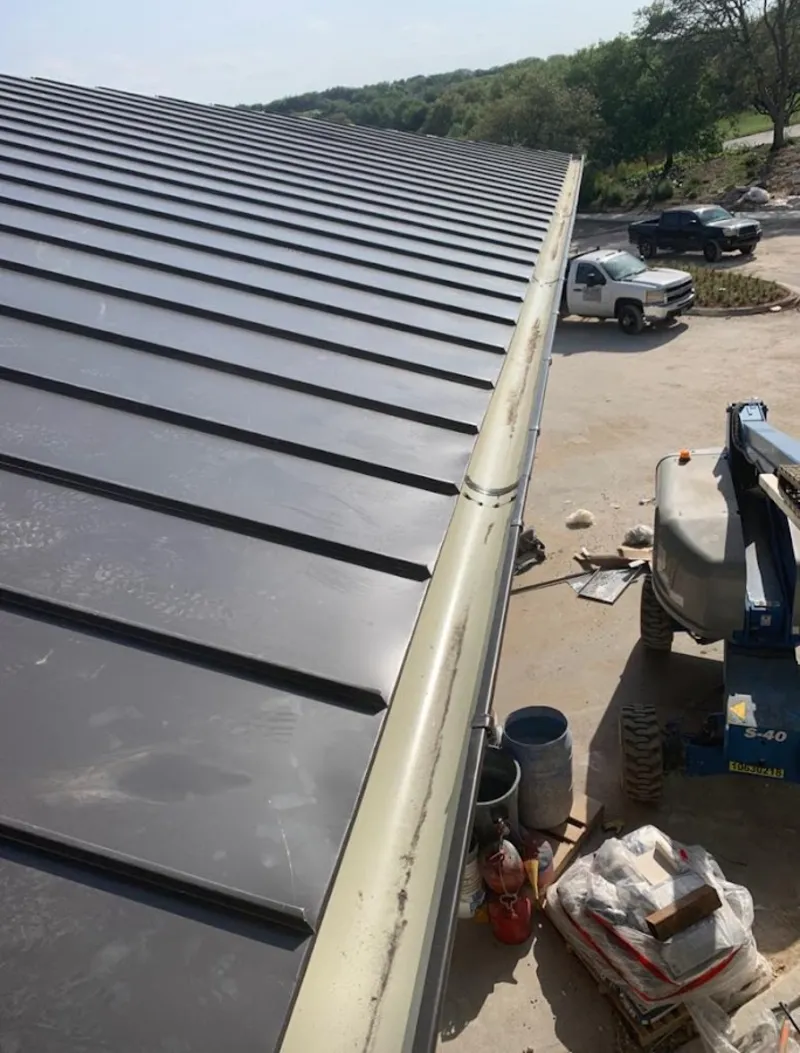 Standing seam panel and gutter detail on a metal roofing jobsite in Delaware